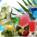 Glasses of cocktails on table on blue sky background